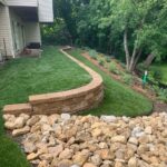 The completed project of a retaining wall and rain garden install