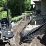 Lawn work being done on a rear patio